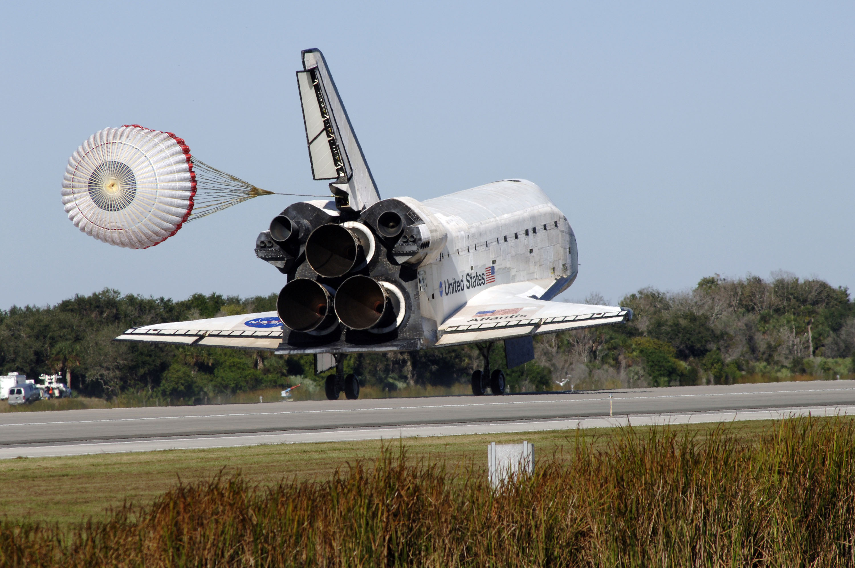 Atlantis deploys its drag chute as it continues down the runway