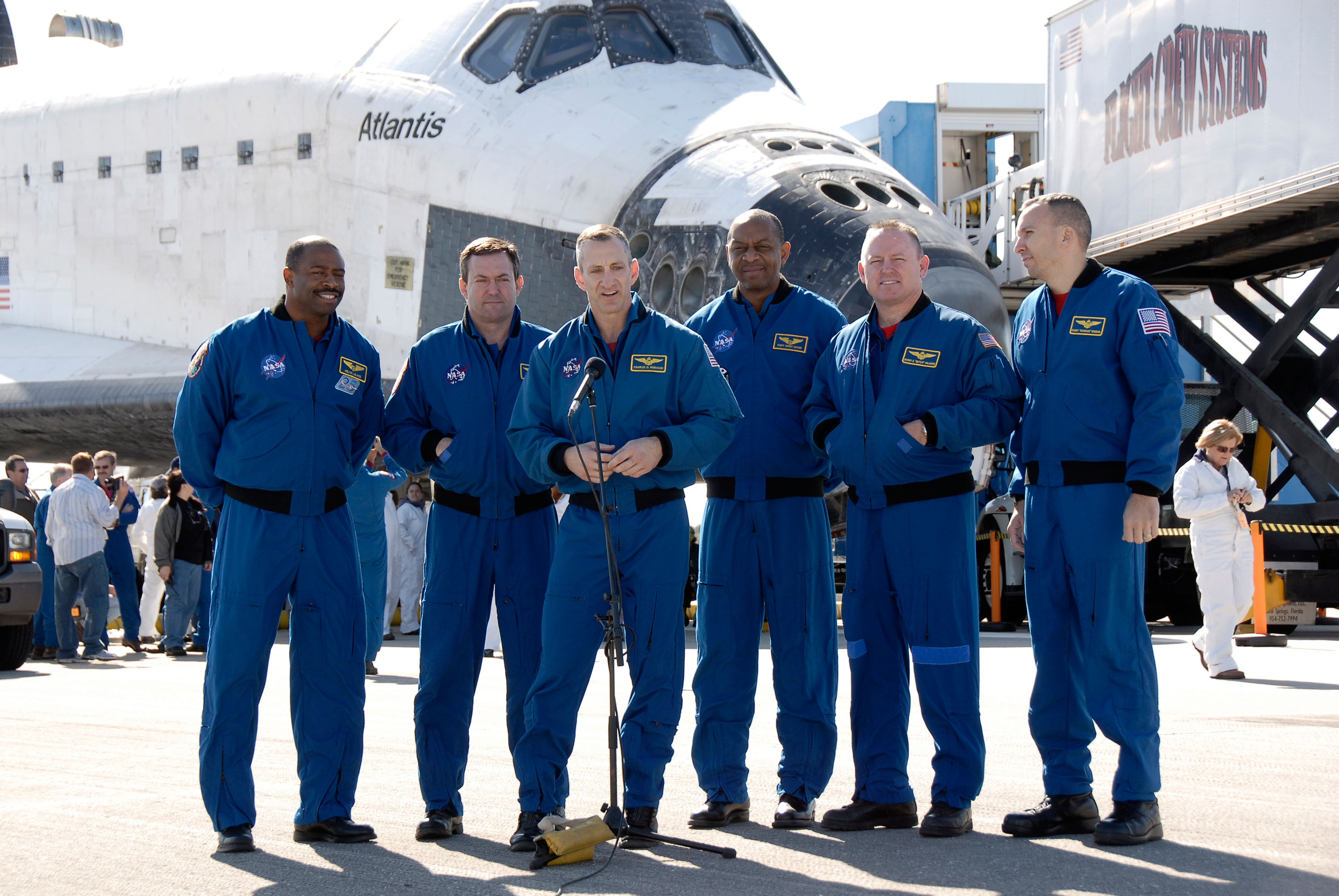 Six of the STS-129 astronauts pose with Atlantis on the runway at NASA’s Kennedy Space Center in Florida