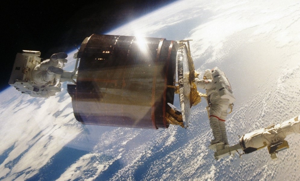 Gardner and Joseph P. Allen maneuver Westar prior to placing it in its cradle in the payload bay