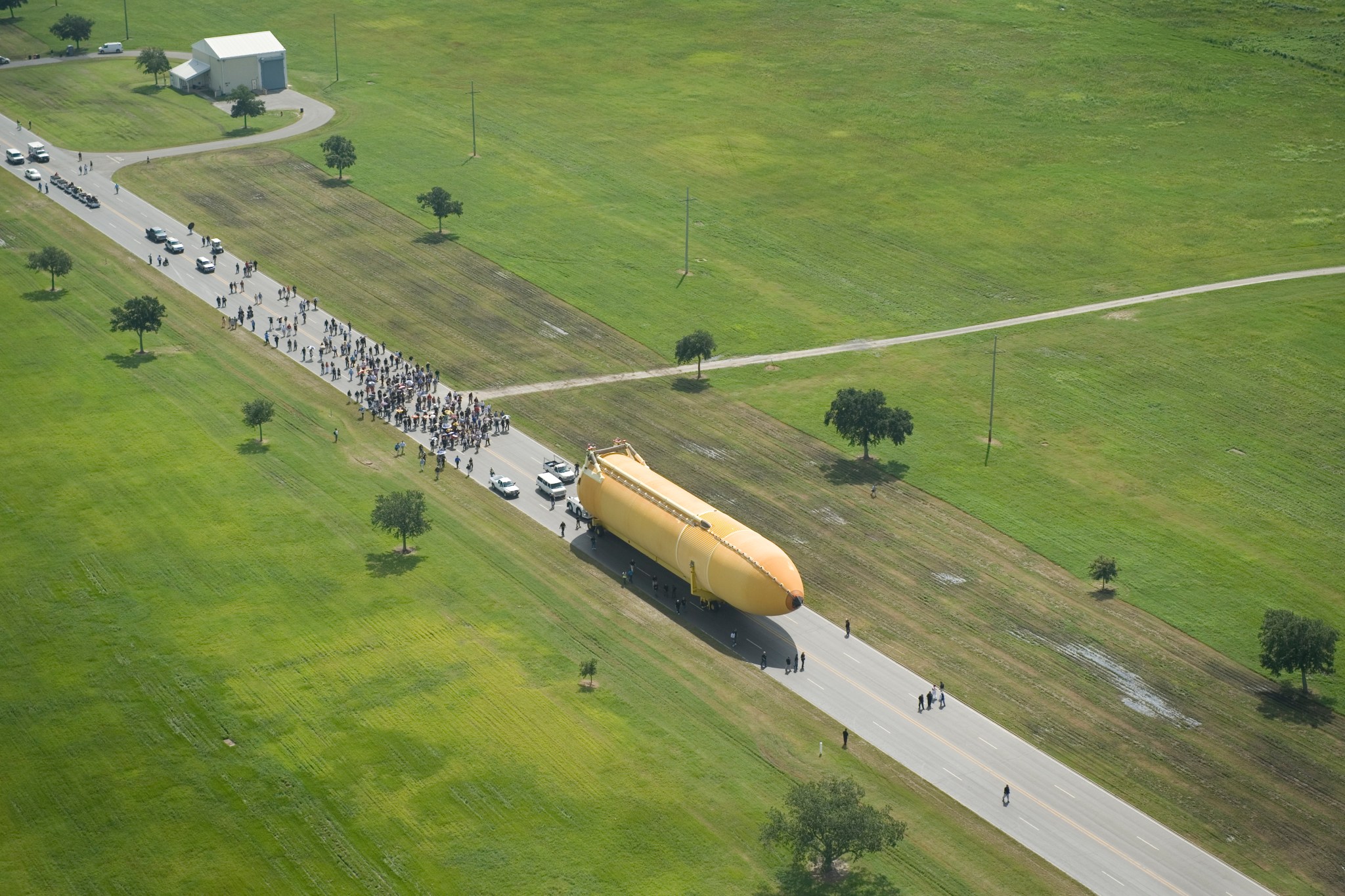 This image shows an aerial view of space shuttle tank ET-138 as it rolls out at Michoud Assembly Facility near New Orleans, Louisiana.