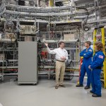 Dan Mitchell, NASA’s lead SLS integrated avionics and software engineer (left), shows Artemis II astronauts Reid Wiseman (center) and Christina Koch (right) software test facilities at NASA’s Marshall Space Flight Center in Huntsville, Alabama.