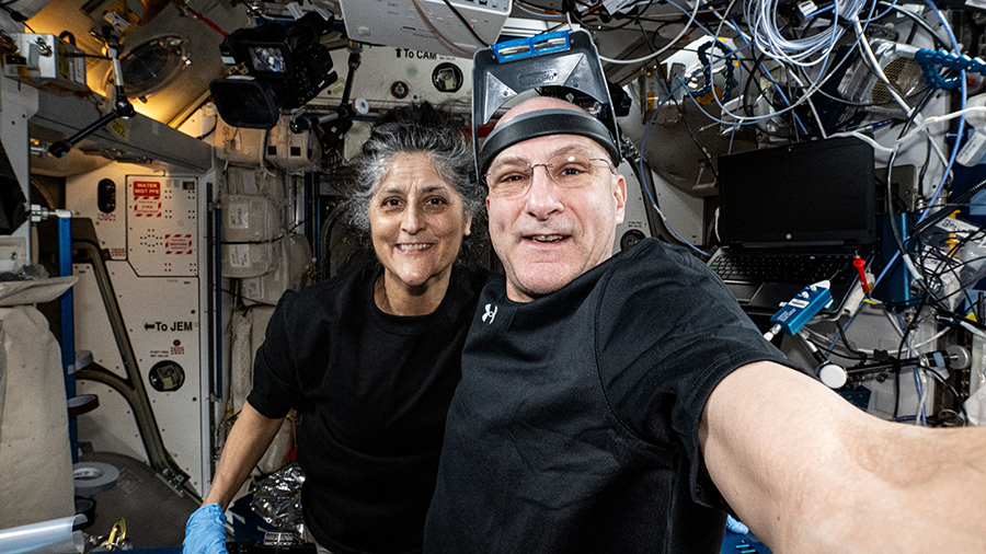 Astronauts Suni Williams and Don Pettit take a break from science maintenance activities and pose for a selfie-portrait aboard the station's Harmony module.