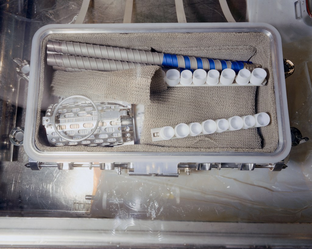 Image of an open aluminum box containing bags and other assorted tools for collecting Moon rocks.