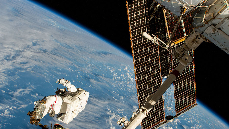 NASA spacewalker Suni Williams is attached to the Canadarm2 robotic arm's latching end effector while being maneuvered 264 miles above the South Pacific Ocean.