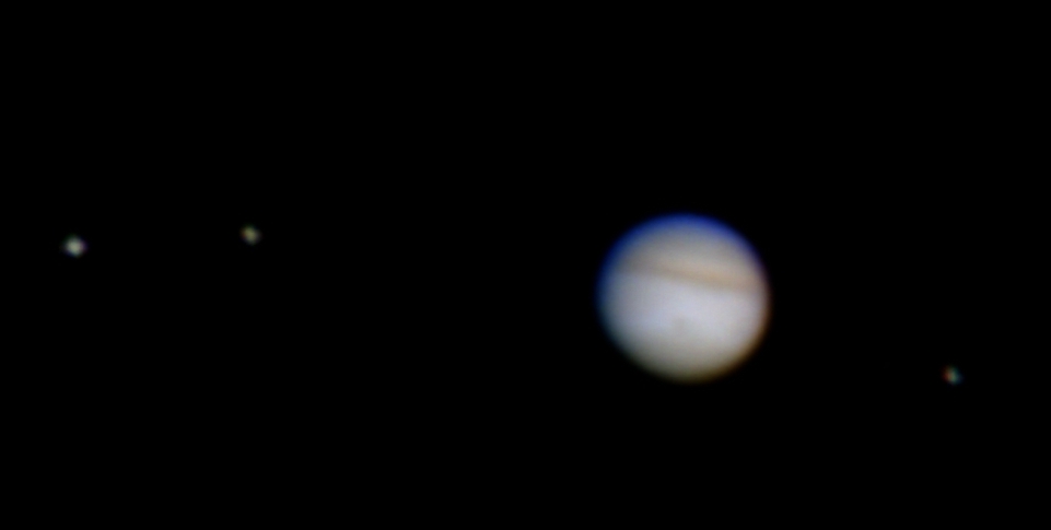 Image of Jupiter as seen through a small telescope, a white disc with a few atmospheric bands