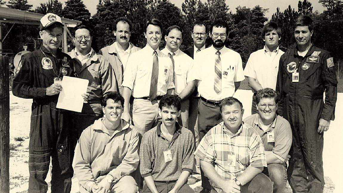 A blended team of 13 NASA personnel and contractors pose for a Diagnostic Testbed Facility group photo