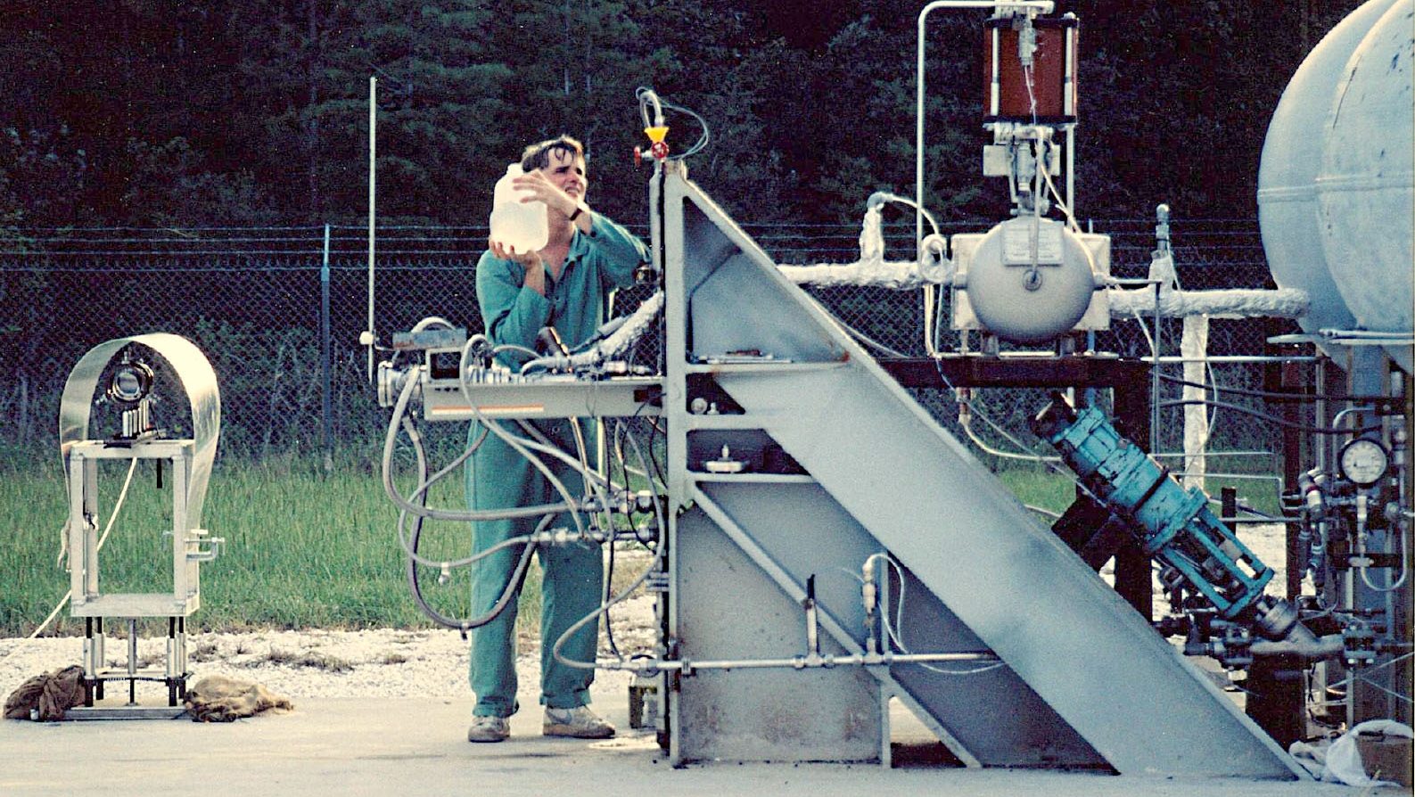 male worker preps the dopant injection system for testing at the Diagnostic Testbed Facility