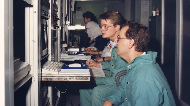 engineers work at control panel