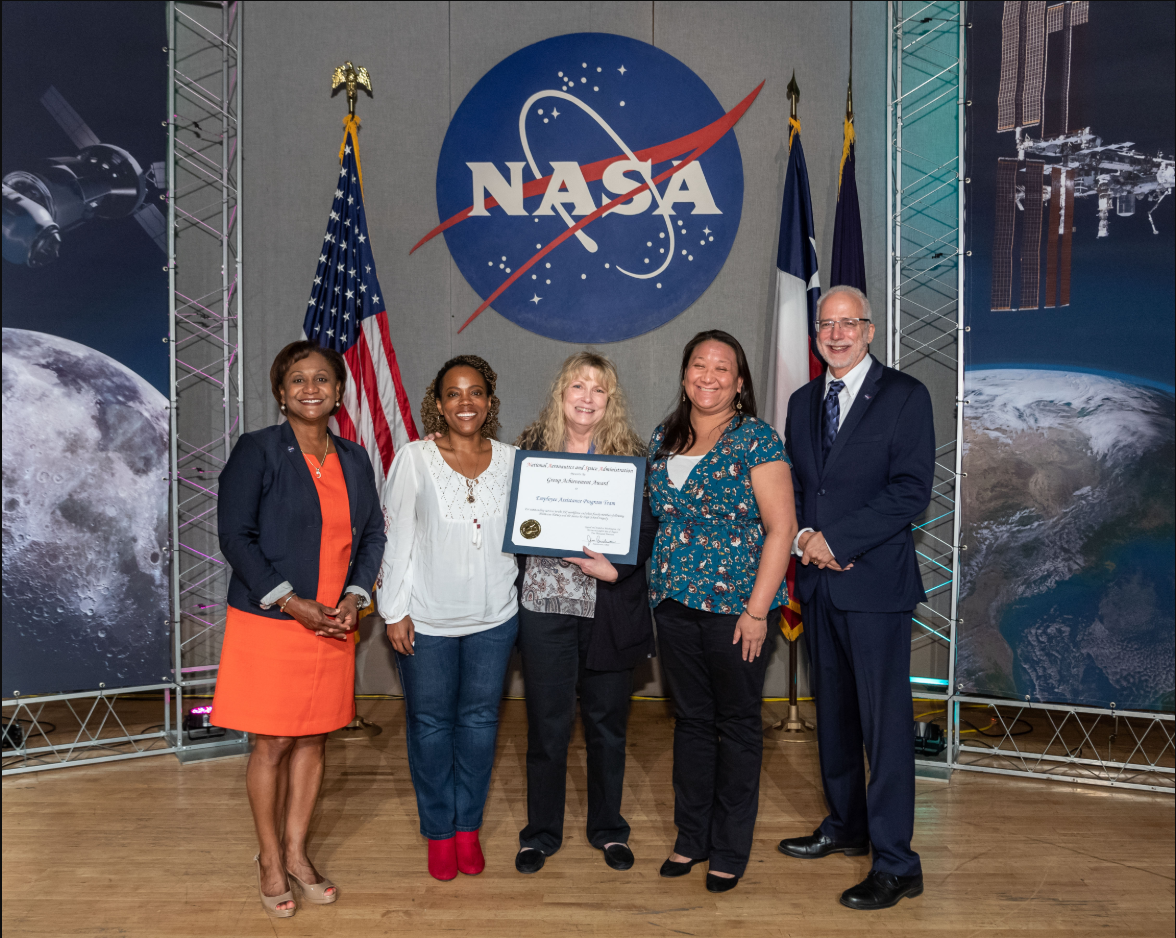 Counselors in Johnson Space Center's Employee Assistance Program receive an award from the center's director and deputy director.