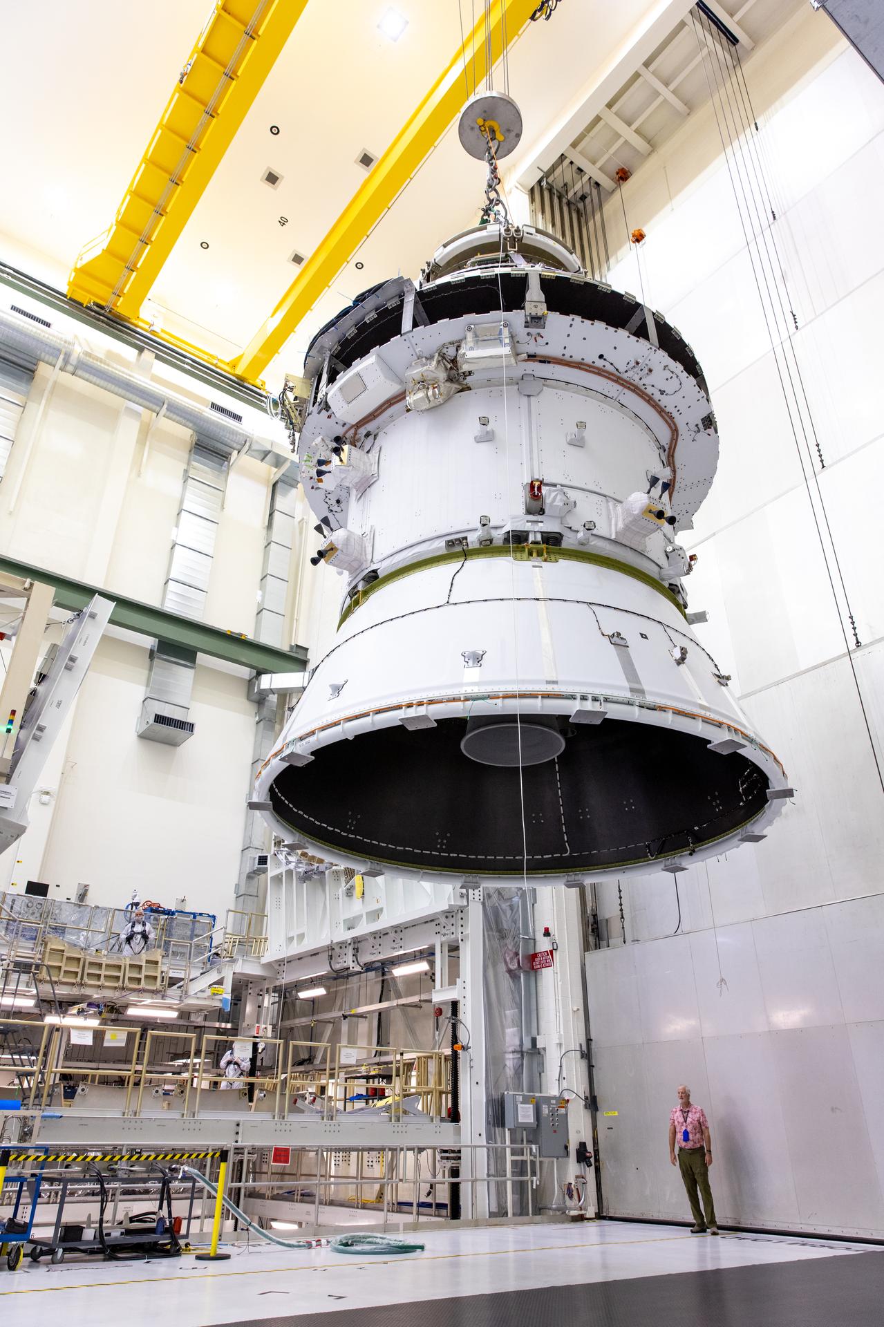 A massive crane lifts NASA’s Orion spacecraft out of the Final Assembly and System Testing cell and moves it to the altitude chamber to complete further testing on Thursday, Nov. 7, 2024, inside the Neil A. Armstrong Operations and Checkout building at NASA's Kennedy Space Center in Florida. The altitude chamber simulates deep space vacuum conditions, and the testing will provide additional data to augment data gained during testing earlier this summer.