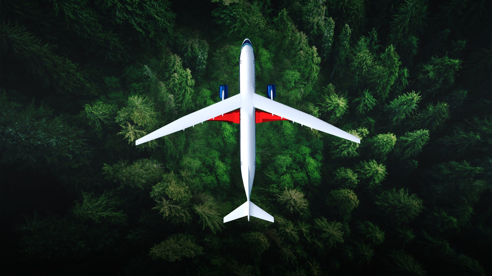 A top view of a truss-braced wing commercial aircraft flying over a forest of green trees.