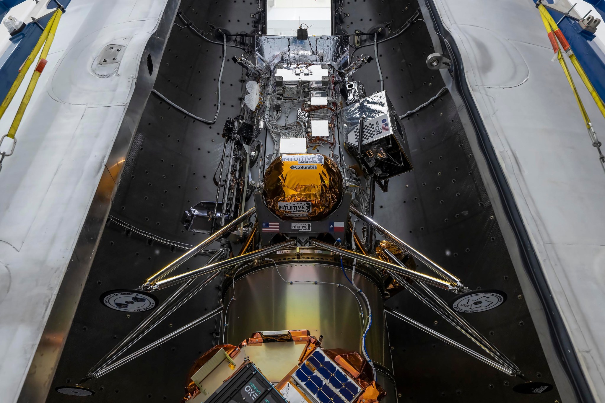 Caption: The Intuitive Machines lunar lander that will deliver NASA science and technology to the Moon as part of the agency’s CLPS (Commercial Lunar Payload Services) initiative and Artemis campaign is encapsulated in the fairing of the SpaceX Falcon 9 rocket. Credit: SpaceX