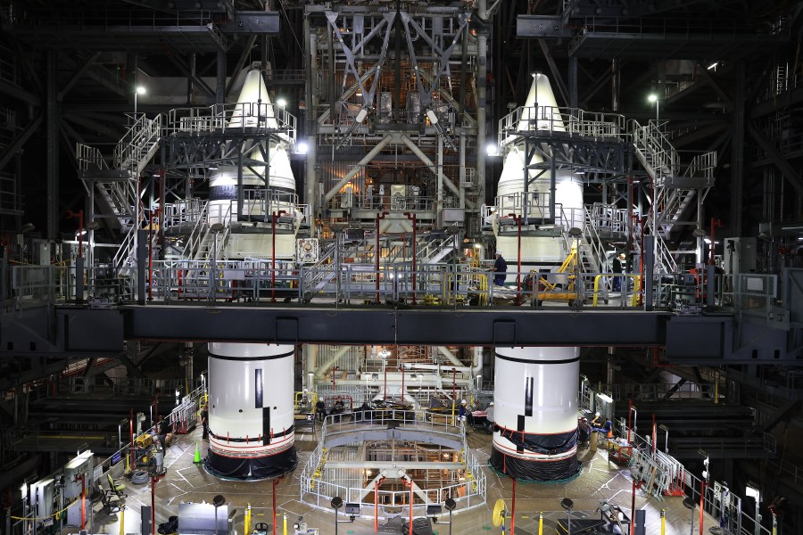 Engineers with NASA’s Exploration Ground Systems complete stacking operations on the twin SLS (Space Launch System) solid rocket boosters for Artemis II by integrating the nose cones atop the forward assemblies inside the Vehicle Assembly Building’s High Bay 3 at NASA’s Kennedy Space Center in Florida on Wednesday, Feb. 19, 2025. During three months of stacking operations, technicians used a massive overhead crane to lift 10 booster segments – five segments per booster – and aerodynamic nose cones into place on mobile launcher 1. The twin solid boosters will help support the remaining rocket components and the Orion spacecraft during final assembly of the Artemis II Moon rocket and provide more than 75 percent of the total SLS thrust during liftoff from NASA Kennedy’s Launch Pad 39B.