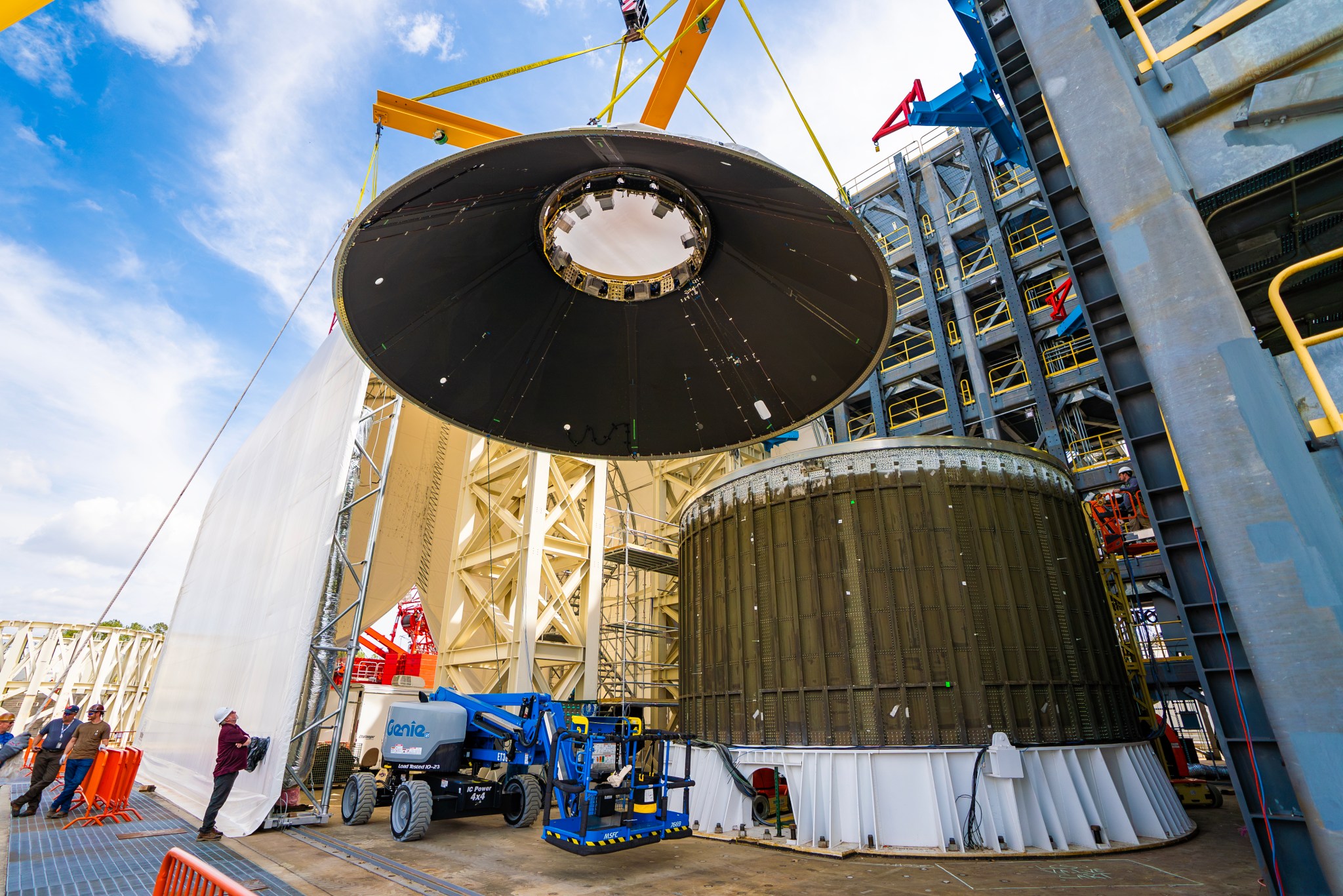 At NASA Marshall, the PLA engineering development unit is installed into the 4697-test stand for structural testing. It was then attached to the large cylindrical structure which simulates the Exploration Upper Stage interface. Load lines were then connected to the top of the PLA.The testing demonstrated that it can handle up to three times the expected load.