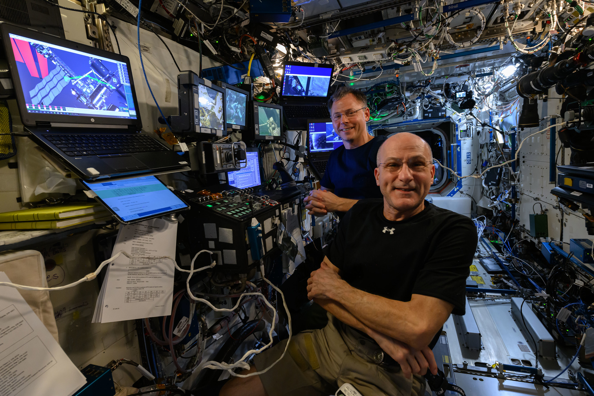 Astronauts Don Pettit and Nick Hague are at the controls of the robotics workstation Credit: NASA