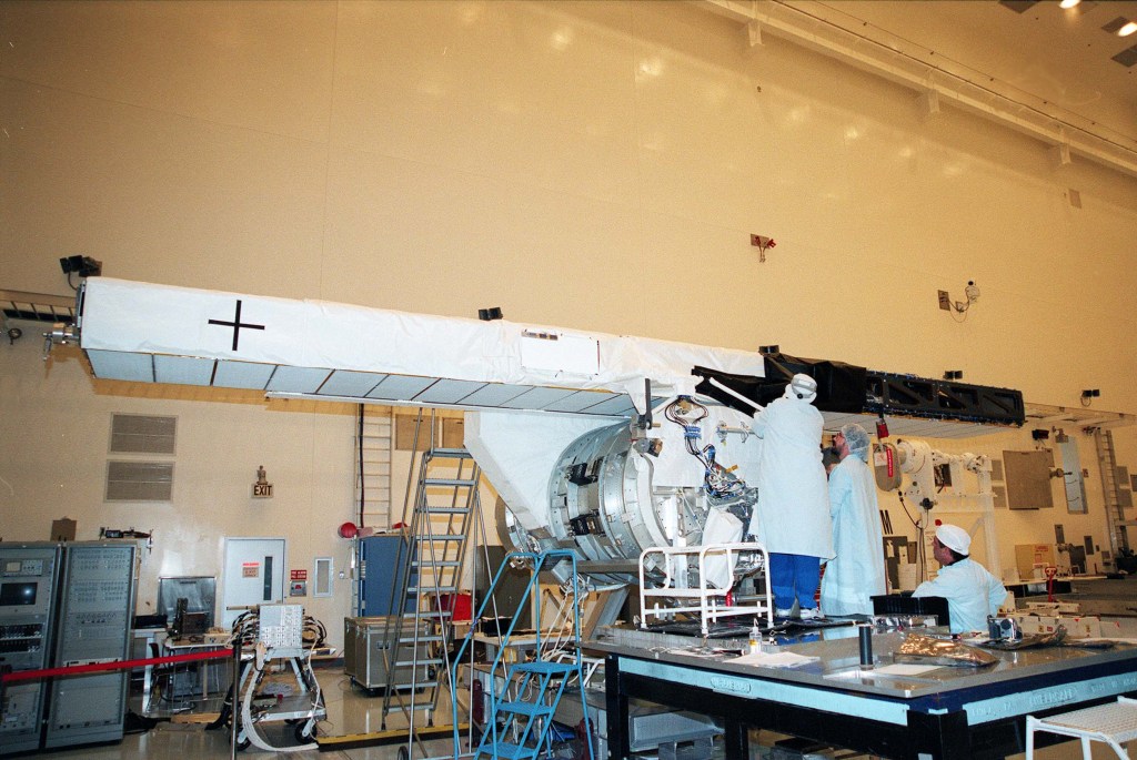 Image of the mast mounted radar antenna during preflight processing in a large high bay.