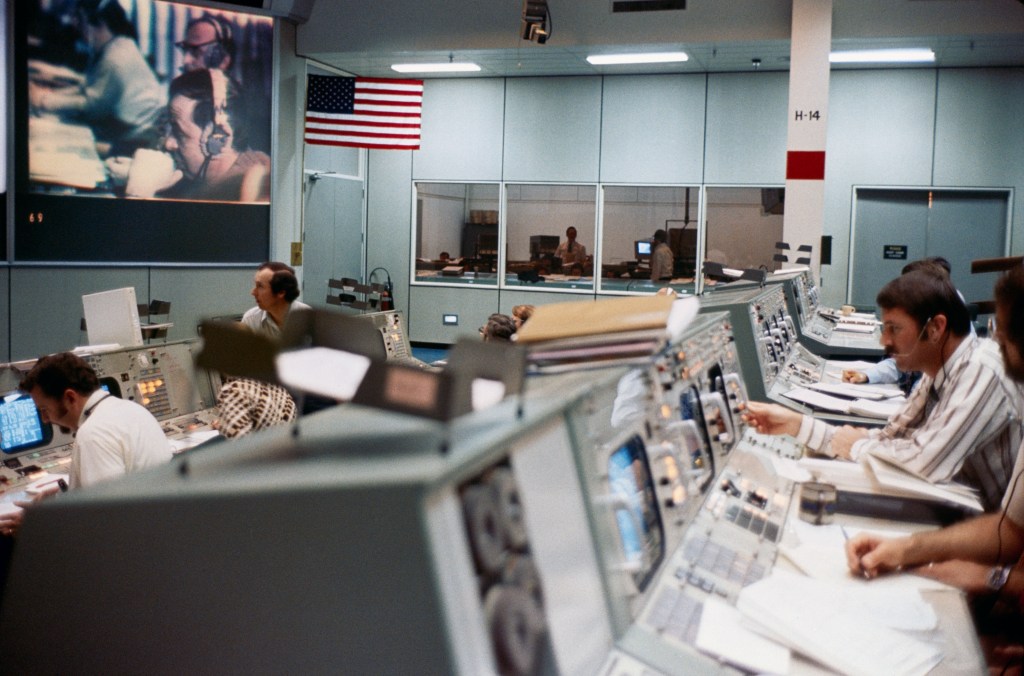 Image of Mission Control, with operators sitting at their consoles.