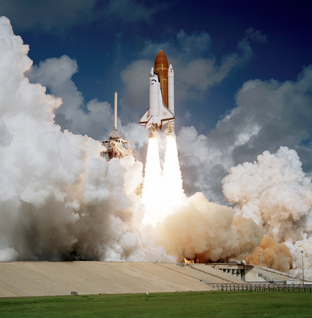 Daytime liftoff of a space shuttle.