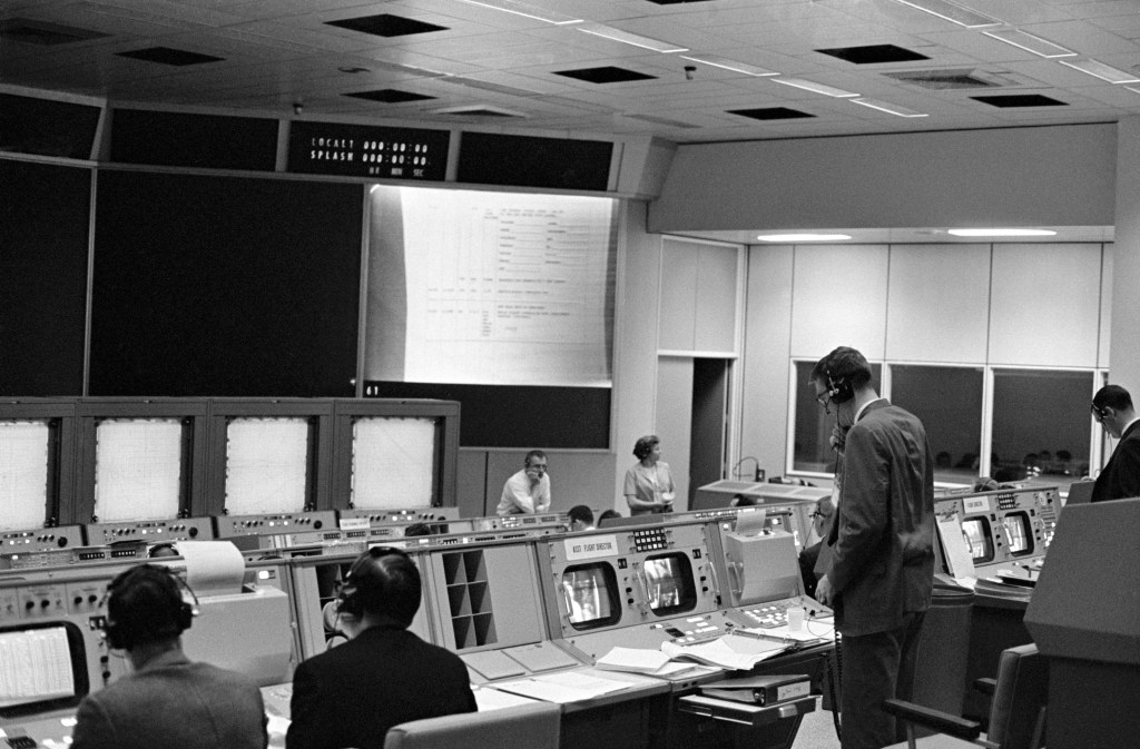 Black and white image of a mission control center.