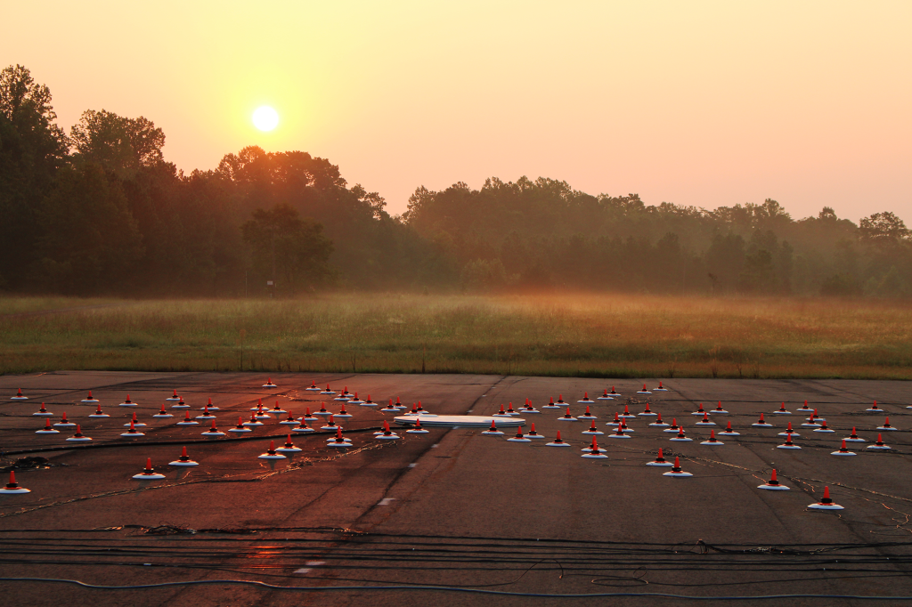 At twilight, an array of microphones test noise at an airfield