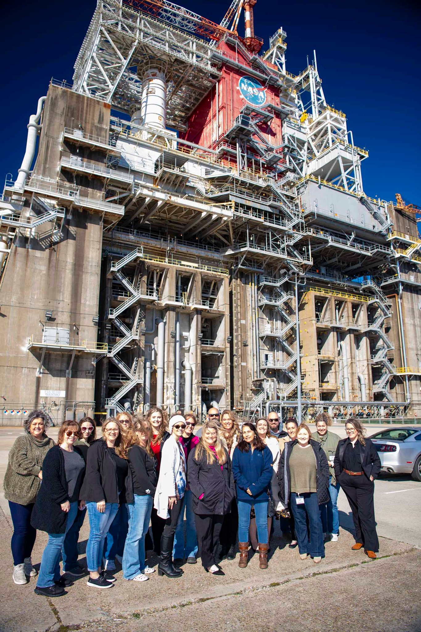 a group of people from the Pearl River County Leadership stand in front of the the Thad Cochran Test Stand