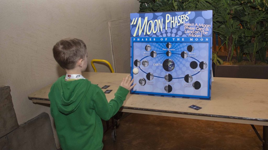 a young event-goer participates in activity provided by NASA Stennis at the Audubon Aquarium