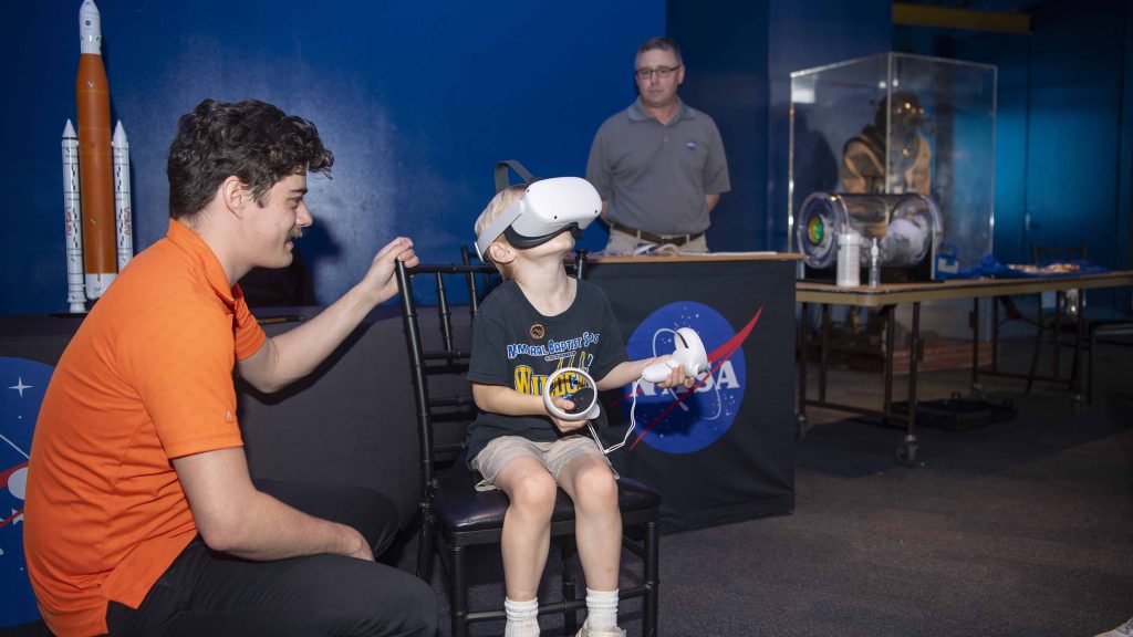 Young child participates in virtual activity provided by NASA Stennis at the Audubon Aquarium