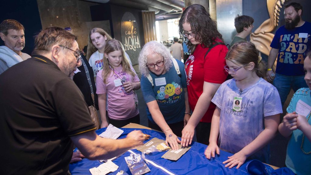 small crowd gathers to watch experiment by NASA Stennis representatives