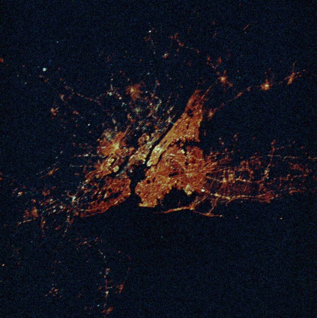 A nighttime view from space of a large city (New York).