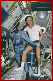 Thagard displays his Mir-18 flight suit