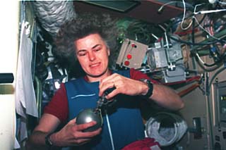 Astronaut Shannon Lucid activates a Grab Sample Container (GSC) to obtain an air sample in the Priroda module. 