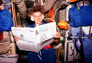 View of astronaut Shannon Lucid reading a St. Petersburg paper in the Mir space station Base Block.