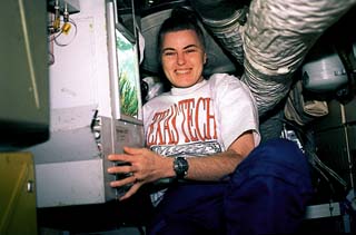 Lucid next to wheat experiment in Mir's Kristall module.