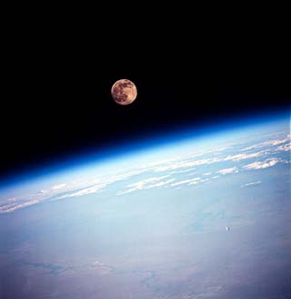 Scenic full moon over Earth horizon.