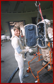 Foale preparing to enter the open back of the Russian Orlan Suit