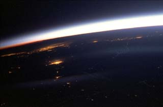 Earth limb  city lights at night.